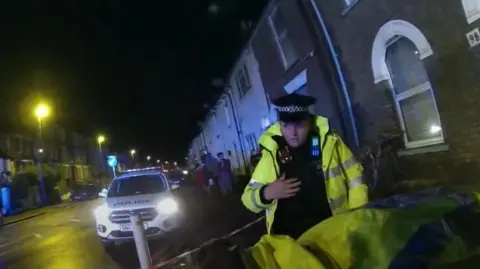 Kent Police Police are on a street at night. 