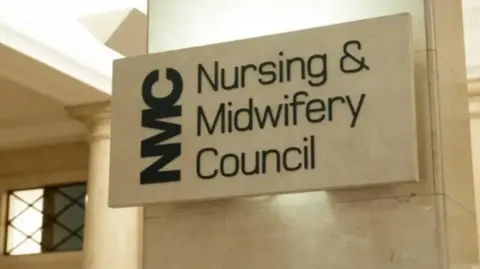 A marble block with the words Nursing and Midwifery Council written on it inside a building.