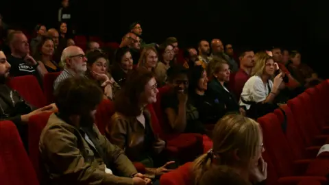 Mark Mecklenburgh, Willow Photography Ltd People laughing in a theatre