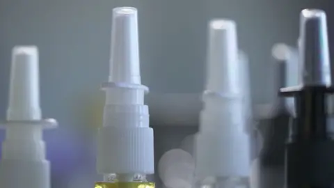 Close up of nasal tanner spray lids of the bottles and caps