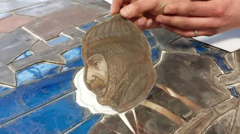 Maison Dieu A stained glass window of a knight.