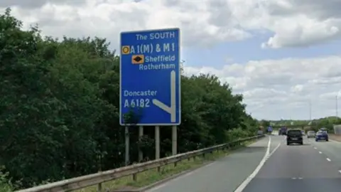 Motorway sign pointing south to Sheffield and Rotherham, with a turn-off to Doncaster.