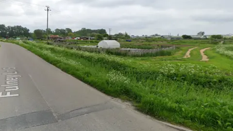 Google street view Allotments with sheds and greenhouses are next to Fulney Lane, a dirt road runs to the right of the photo. 