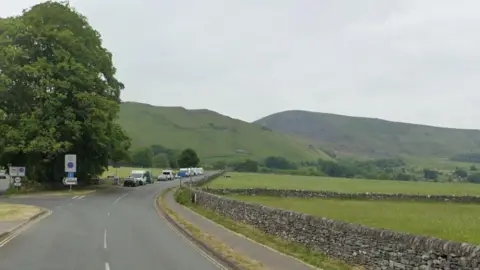 A street view of hills surrounding Old Mam Tor Road,