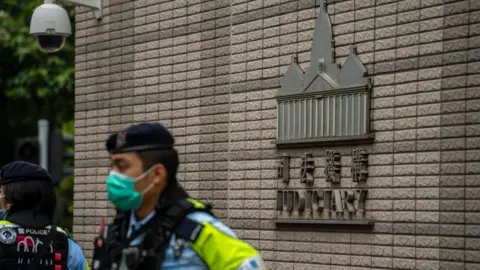 Getty Images A police officer outside the West Kowloon Magistrates Court during the Hong Kong 47 case verdict in late May 2024