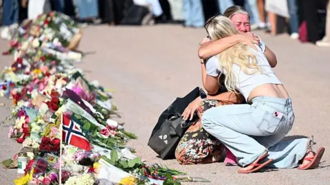 People are gathering at The Palace Square to pay their respect to King Harald V of Norway who is at Oslo University Hospital in a serious condition on August 27, 2026 in Oslo, Norway
