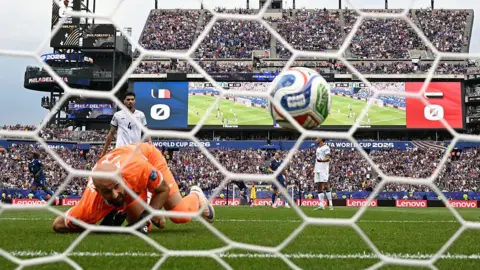 Iraq goalkeeper Ahmed Basil looks on as France forward Kylian Mbappe's shot hits the net in the World Cup group game in Philadelphia on 22 June, 2026