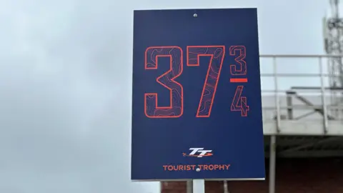 BBC The 37.7-mile milestone at the return lane at the grandstand