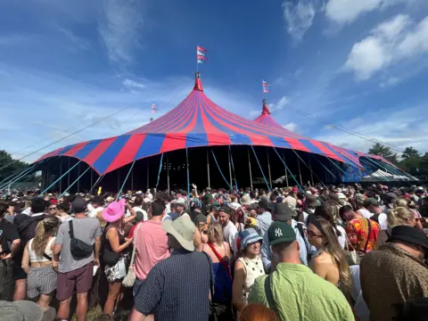 Fans crowd outside the Woodsies tent at Glastonbury