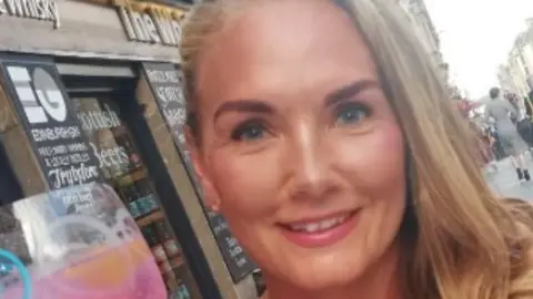 Family handout Carly Wealleans smiles at the camera. She has long blonde hair and blue eyes.