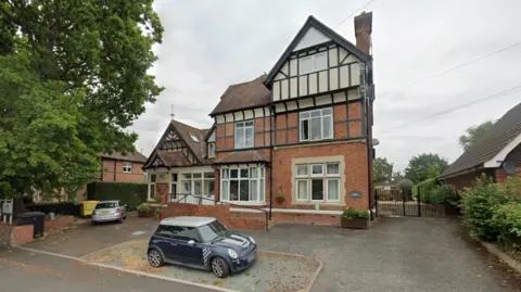 Google Maps A three storey Edwardian house pictured with a blue Mini Cooper parked outside it.