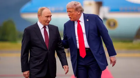 Getty Images Donald Trump greets Vladimir Putin as he arrives at Joint Base Elmendorf-Richardson on 15 August 2025 in Anchorage, Alaska.