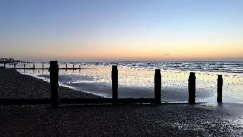 jollyjoan A beach at sunset. The tide is very high. 