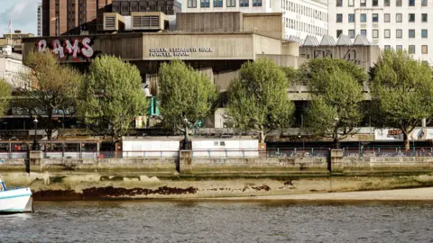 A view of the National Theatre - a brutalist building - from the other side of the Thames