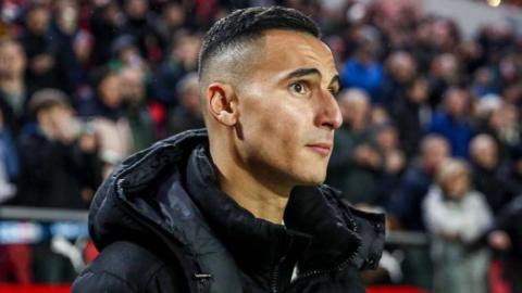Anwar El Ghazi in a jacket at pitchside during a match