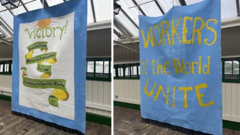 Nexus Two banners which have been entirely painted to read: "Victory! Shankhouse Women's Section of the Cramlington Labour Party" and "Workers of the World Unite".