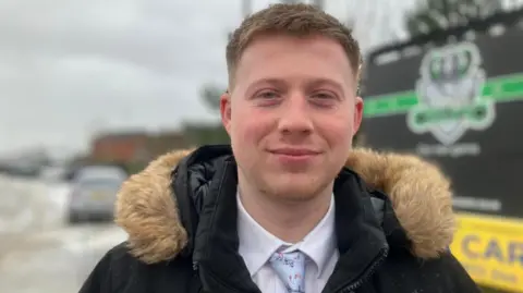 BBC / Elizabeth Baines George Fearnely, a Farsley Celtic fan, standing outside the Farsley Celtic football ground