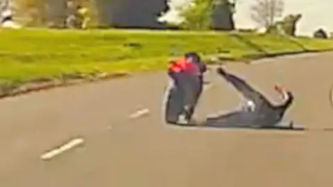 Man falls off bike.