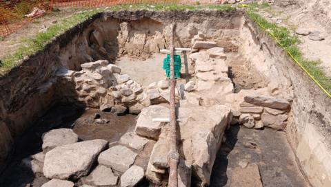 A 3m by 5m excavation uncovering part of an Iron Age round house