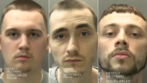South Wales Police A trio of custody shots. The men look straight at the camera. They all have short brown hair and stubble, Bateman has a dark, short goatee. 
