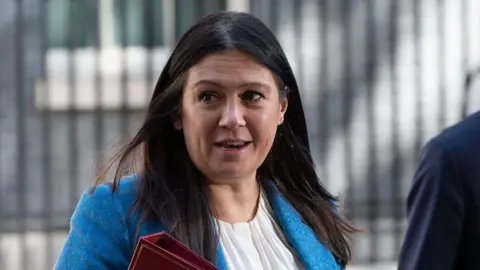 Lisa Nandy carries a red folder as she walks along Downing Street.