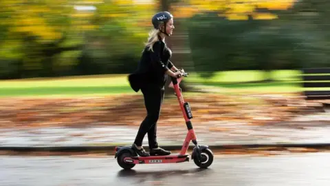 Voi Woman on e-scooter