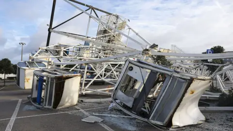 EPA A Ferris wheel collapsed due to the storm.