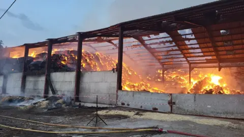 DWFRS A barn containing hay bales on fire