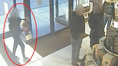 Nottinghamshire Police A still of CCTV with a woman ringed in red