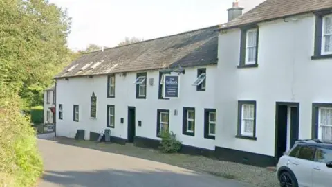 Google A Google Street View screenshot of the Kellbank hotel and restaurant in Gosforth. The building is on a small street and looking like a typical black and white Cumbrian cottage.