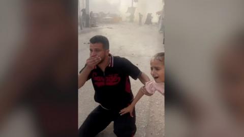 Man and child in shock after Gaza blast