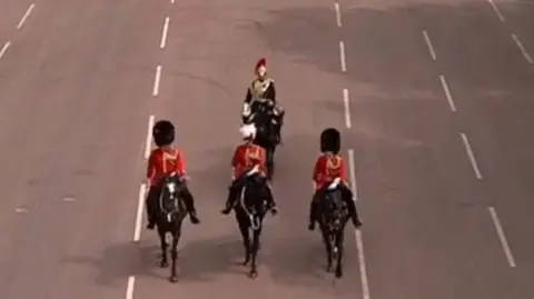 Three solders on horseback take part in the VE Day military parade