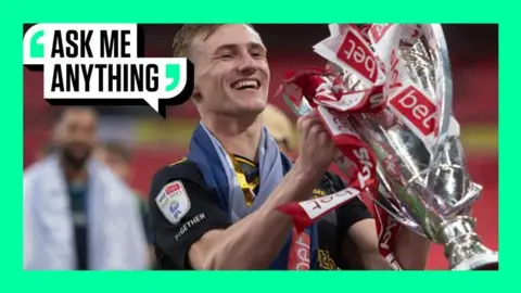 Flynn Downes lifting the Championship play-off trophy 