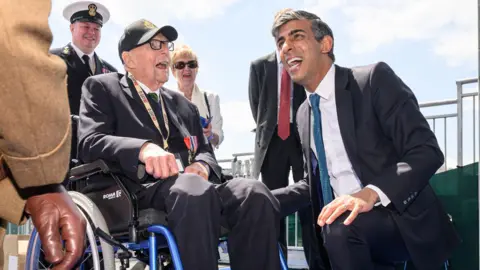 PA Media Rishi Sunak speaing to veterans in France