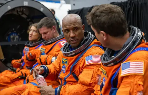 NASA The Artemis II crew ahead of emergency egress training in the Orion Mockup. From right is NASA Commander Reid Wiseman, NASA Pilot Victor Glover, CSA (Canadian Space Agency) Mission Specialist Jeremy Hansen, and NASA Mission Specialist Christina Koch.