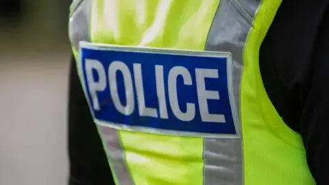 The back of a luminous police uniform jacket.
