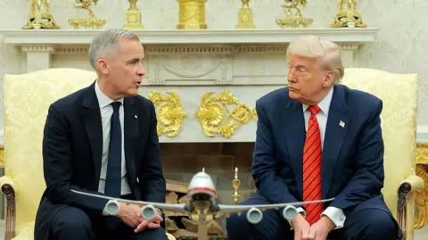 U.S. President Donald Trump speaks to reporters alongside Canadian Prime Minister Mark Carney in the Oval Office at the White House on May 6, 2025 in Washington, DC.