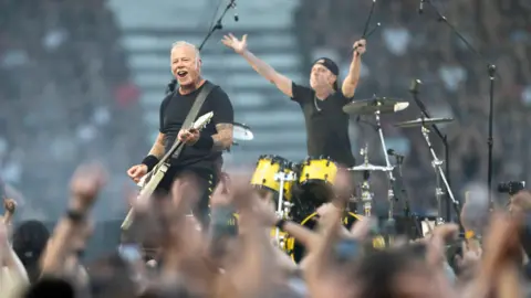 James Hetfield (L) and Lars Ulrich of the US heavy metal band Metallica perform during their concert at the Letzigrund Stadium in Zurich,