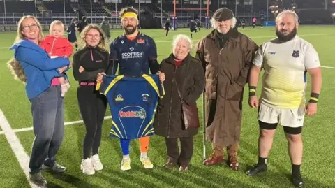 Grant Anderson Grant Anderson with his wife, children, parents and brother at the end of his last rugby match playing for Edinburgh Inclusive Rugby Team