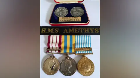 Andrew Bannister Sammy Bannister's medals, three have striped ribbons and two are in a case.