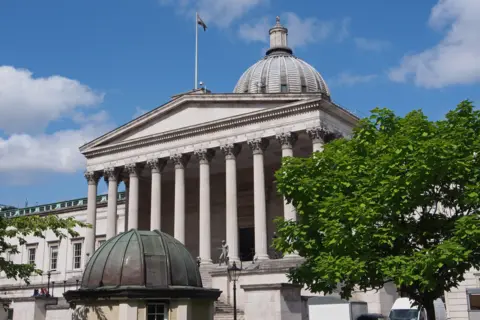 Getty Images A dome sits above a building with 10 columns. A tree is to the right