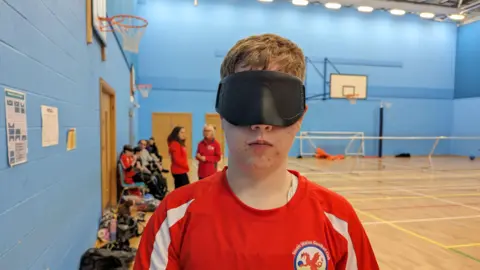 Family photo Gareth preparing to play goalball