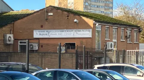 Henry Godfrey-Evans/BBC A building with "Metrow Foods Ltd" written on the side