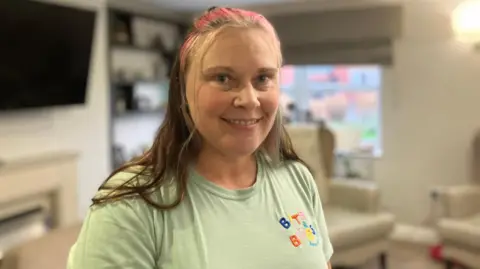Emma Wragg, wearing a 'Bits and Bobs' t-shirt, looking at the camera