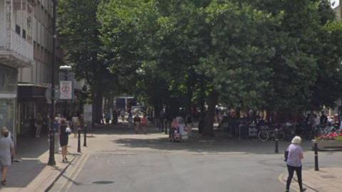 People walking along the Promenade in Cheltenham