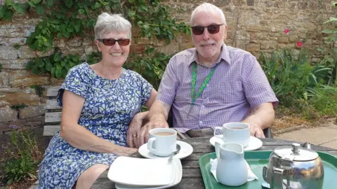 A woman and a man sitting having a cup of tea