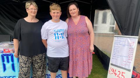Sam is pictured with grandmother Barbara and mum Nicola