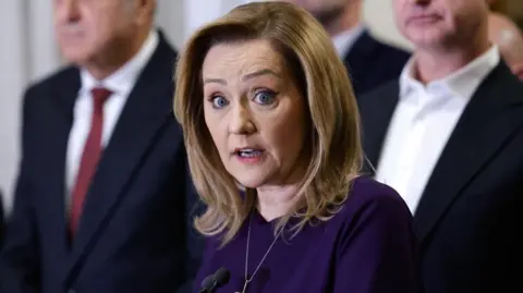 EPA  Elena Lasconi, a blonde woman wearing a purple dress, speaks