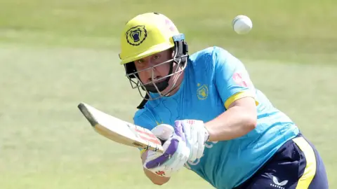 Warwickshire's Abbey Freeborn plays a shot