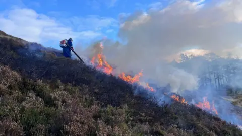 Leaf blowers being demonstrated on controlled burning of moorland in Aberdeenshire